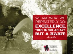 Two firefighters putting water on a fire with quote &quot;We are what we repeatedly do; excellence, then, is not an act but a habit&quot;